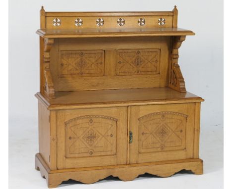 Victorian oak Gothic Revival buffet cabinet, circa 1875, having a back panel pierced and carved with flowerheads and a single