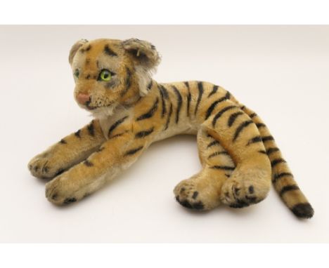 Vintage Steiff recumbent tiger cub, remnants of cloth label in ear, 35cm