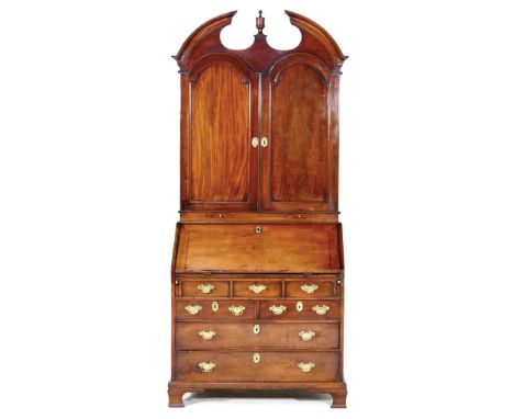 George III mahogany bureau bookcase, circa 1770, the top with a broken cavetto arched cornice centred with an urn shaped fini