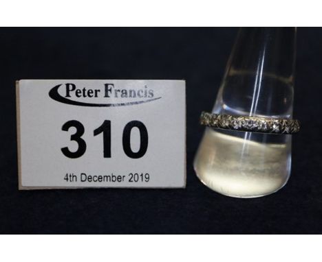A diamond full eternity ring of twenty four brilliant cut diamonds set in white metal. Ring size V. Weight 3.9g approx. (B.P.