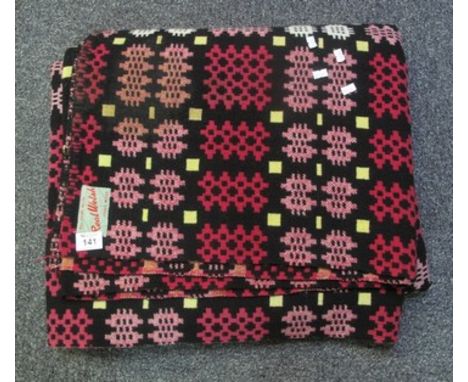 Vintage woollen Welsh tapestry blanket with geometric design on black ground and 'All pure wool, Real Welsh, hand made' label