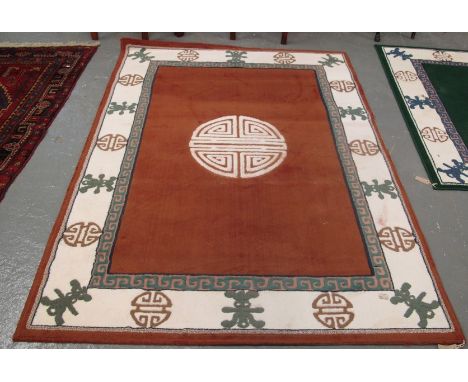 Large modern carpet on a multi-coloured geometric ground, together with a modern orange geometric design carpet. (2)(B.P. 24%