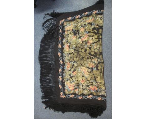 A vintage black ground floral design shawl with woven in gold floral and bird pattern and fringed edge.(B.P. 24% incl. VAT) C