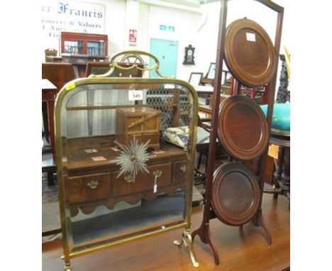 Edwardian mahogany inlaid three section folding cake stand, together with a brass framed mirrored firescreen with sunburst de