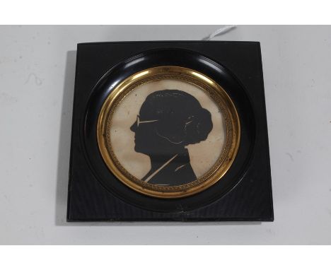 Art Deco framed silhouette, depicting a lady in profile wearing glasses, the reverse reading by Peggy Newall, 1931, 10.5cm wi
