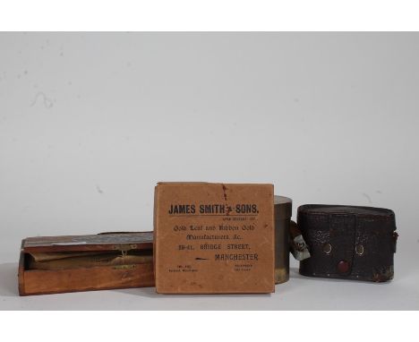Two boxes containing gold leaf, brushes, together with a brass cylindrical box and cover and a camera (4)