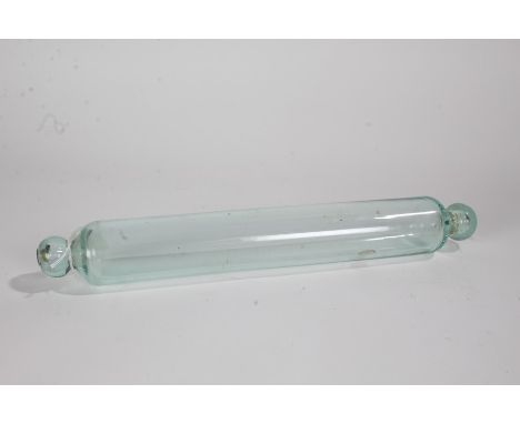 Early 20th century green glass rolling pin, containing a three pence piece, 40cm long