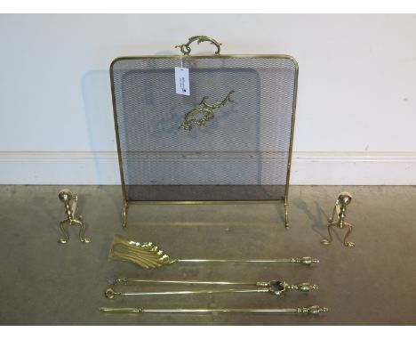 Three piece brass fireside set to include three fire tools, pair of fire dogs and spark guard - all in polished condition 
