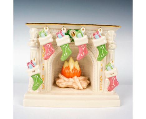 A figure depicting a white fireplace in use with 6 decorative stockings that hang from the hooks of the fireplace. Lenox back