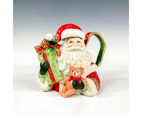 Glaze finish porcelain teapot featuring Santa Claus with teddy bear and large present in hands. Fitz and Floyd backstamp. Thi