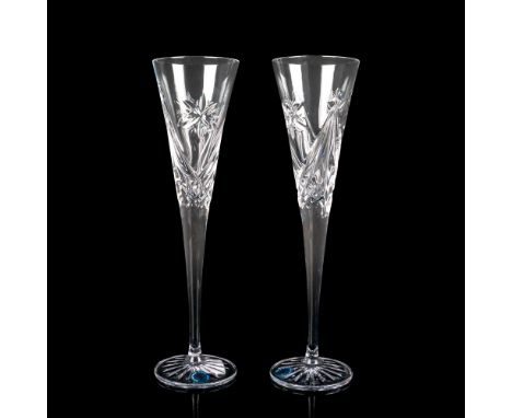 Unique tall champagne glasses decorated with snowflakes and crisscross pattern, Waterford factory label and etched backstamp.
