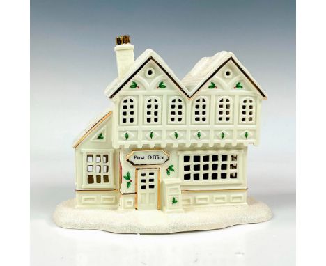 A fine porcelain decorated with hand applied glitter and gilded borders. Christmas Village collection. Building lights up wit