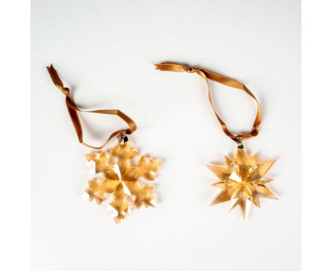 Lead golden crystal piece part of the Christmas Ornaments collection, hanging on a light-brown satin ribbon. Swarovski etched