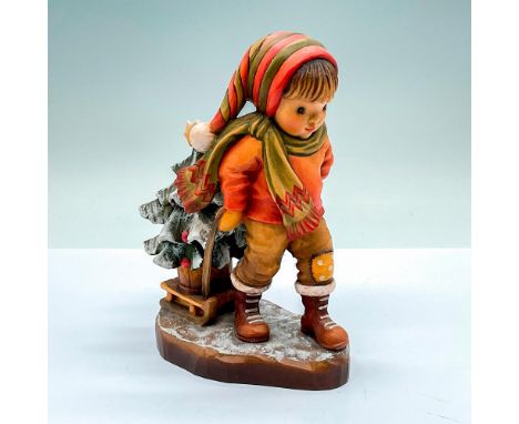 Limited edition. A vintage wooden carved figure of a boy pulling a decorated Christmas Tree on his sled. Artist carved name o