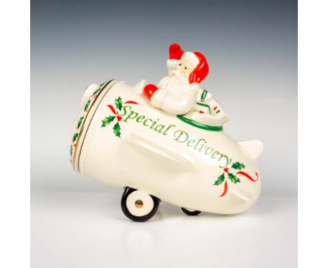 Elegant but whimsical figural cookie jar of Santa in the classic Lenox white, flying in an old-fashioned plane to delivery pr