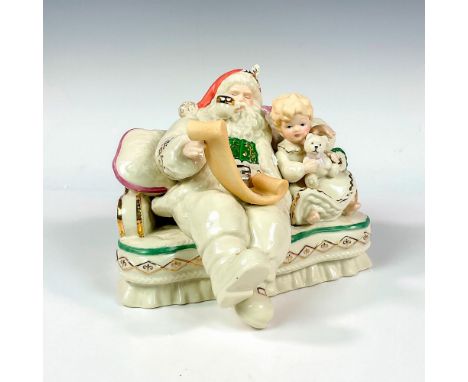 Ivory-colored porcelain figure with gilt accents. Depicting Santa and a young child reading a list. Lenox backstamp. This ite