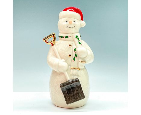 Exclusive to Macy's, the Lenox Snowman with Shovel Figurine is a charming holiday ornament. Crafted from fine Lenox ivory por