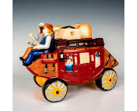 This charming ceramic hand-painted cookie jar depicts a stagecoach carrying passengers, being driven by two cowboys. This ite