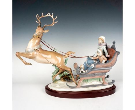 Glossy finished porcelain figure grouping of two children riding in a reindeer-driven sleigh. Lladro backstamp. This item has
