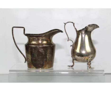 A silver cream jug, of helmet form, Birmingham 1919; and another of baluster form on three volute legs, London 1896, 200grs (