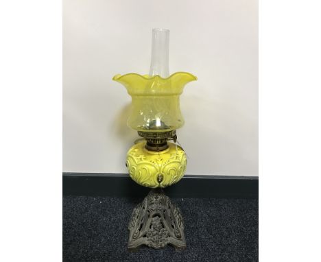 An early 20th century Duplex oil lamp with a yellow glass shade  CONDITION REPORT: Hairline to shade. Otherwise in good/fair 