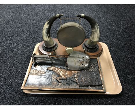 A tray of embossed panel depicting a pointer, horn-mounted dinner gong on oak plinth (lacking beater), shoe stretchers