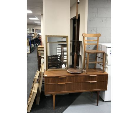A teak four drawer chest, a teak standard lamp, child's chair and two gilt framed mirrors 