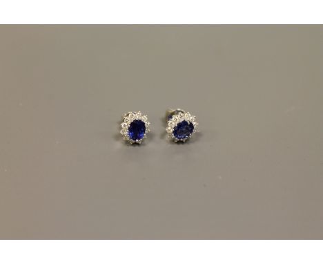 A pair of 18ct white gold sapphire and diamond cluster earrings CONDITION REPORT: The earrings are in good condition. Gross w