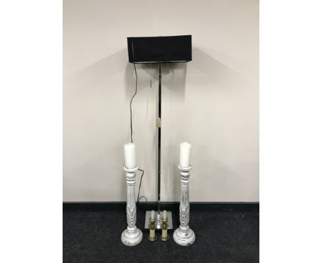 A contemporary chrome standard lamp, pair of brass candle holders and a pair of carved wooden candlesticks 