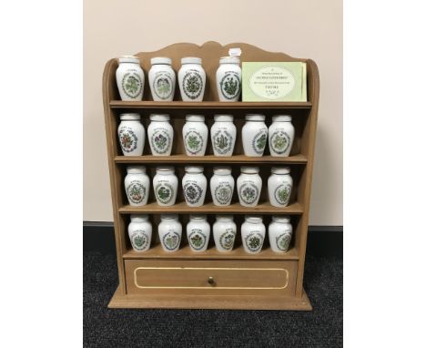 A spice rack containing twenty two china Gloria Vanderbilt spice jars 