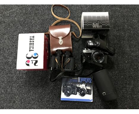 A basket of Yashica FR camera, Yashica 35 Model M camera, lens, binoculars etc 