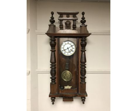 An Edwardian mahogany wall clock with enamelled dial 