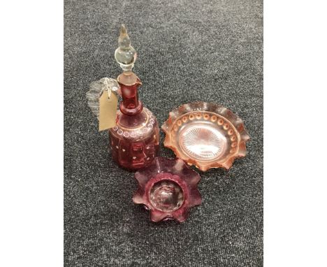 An early 20th century cranberry glass decanter and bowl and a pink glass bowl 