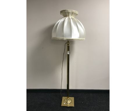 A brass column standard lamp and shade 