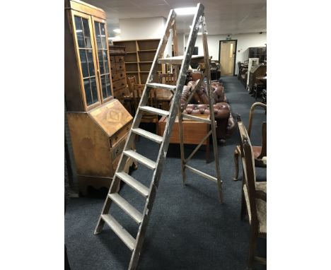 A set of folding wooden step ladders 