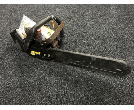 A Mcculloch electric chain saw with manual and spare chain 