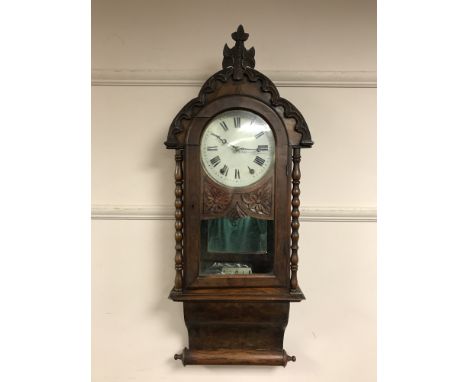 A 19th century mahogany wall clock with mirrored panelled back 