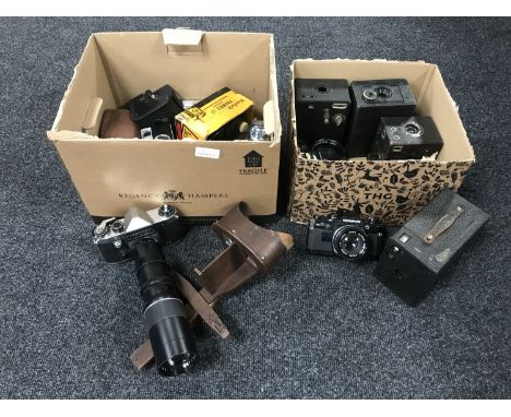 A box of assorted cameras and lenses - Zenit, Praktica Super TL, Olympus OM10, Brownie camera etc and a Stereoscope viewer 