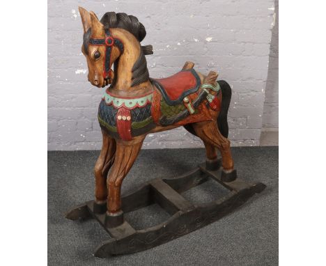 A wooden carved and painted rocking horse.  