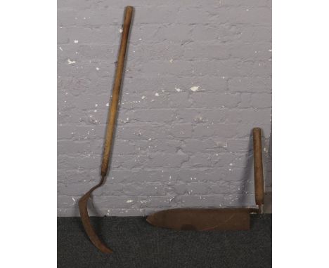 A vintage farmers hedging bill along with a scythe.  