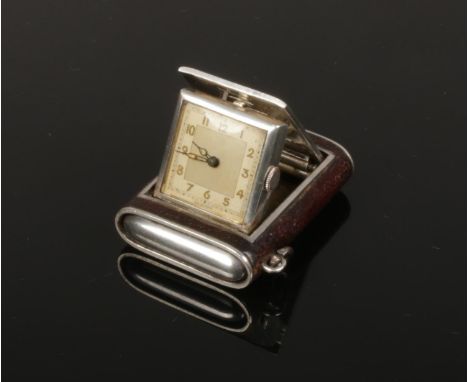 A 1920s leather mounted silver Art Deco folding purse watch housing a Swiss movement, 45mm.  Working. Adjuster working. Case 