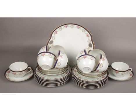 An Austrian Victoria china part teaset decorated with roses. Ten cups, nine saucers, twelve side plates and a bread and butte