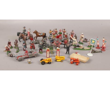 A collection of assorted vintage lead toy soldiers, horses and figures to include Lesney die cast vehicles Caterpillar exampl