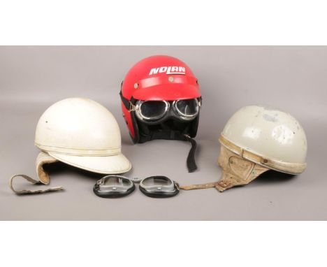 A collection of helmets, Nolan motorbike helmet with goggles, Lycett, Geno Paris  examples  