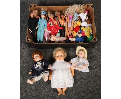 A box of dolls including Barbies and Action Man figures.  