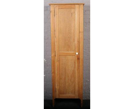 A large vintage slender panelled pine cupboard. 66cm wide x 206cm tall.  Some superficial marks.