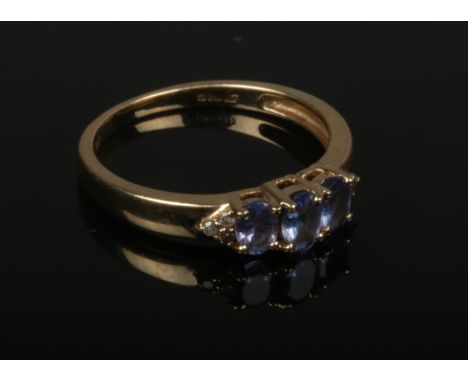 A 9ct gold tanzanite and diamond dress ring. Size L.  