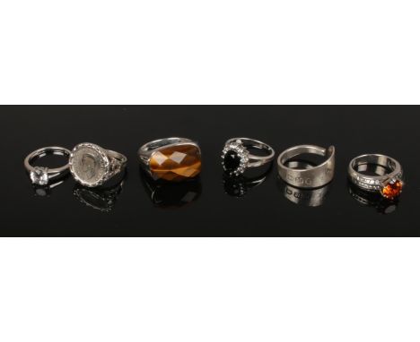 Six silver dress rings including Georgian spoon ring, tigers eye, and coin set examples.  