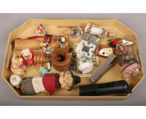 A tray of collectables including wooden nut cracker, bottle openers and other trinkets.  