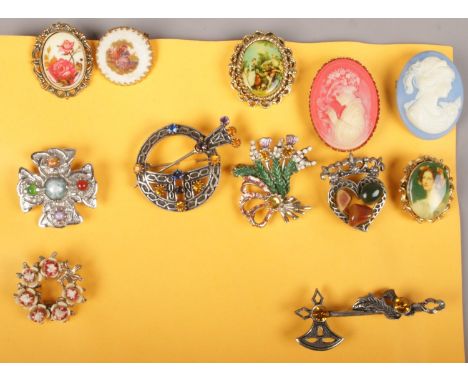 Twelve vintage costume jewellery brooches including Scottish examples.  